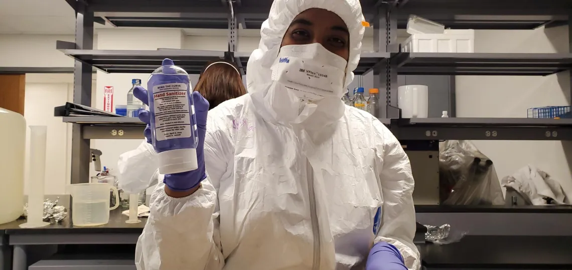 Shylaja Ramamurthy holding a bottle of VVL-made hand sanitizer, mid-Covid Pandemic. 